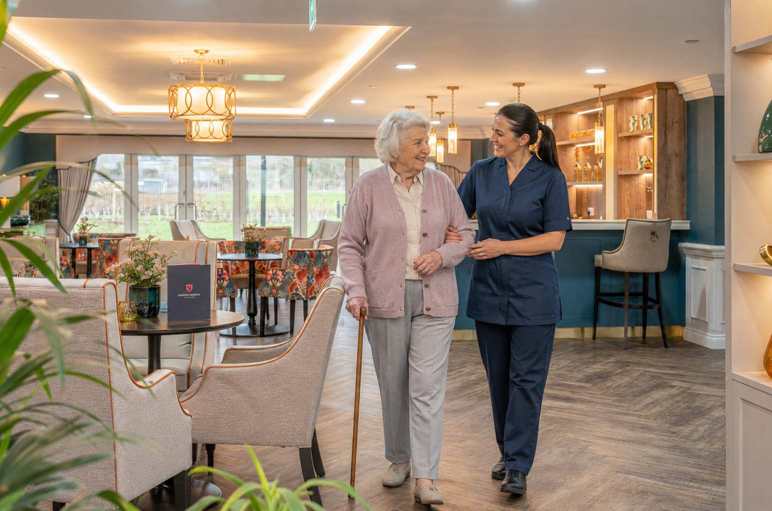 Esmere Gardens nurse walking alongside a resident receiving nursing care