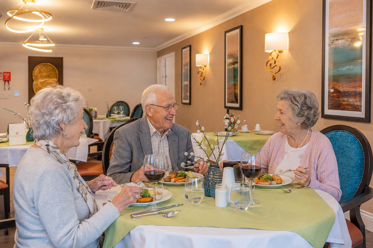 Residents enjoying a sociable dining experience at Esmere Gardens